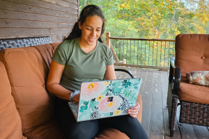 a woman travel agent booking a trip for a client during a cabin getaway.