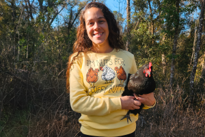 a woman holding a chicken. post on a blog post talking about how to use eggshells as a calcium supplement.