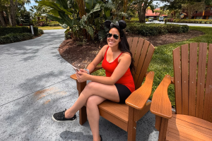 a woman travel agent working from her phone planning a trip for her clients.
